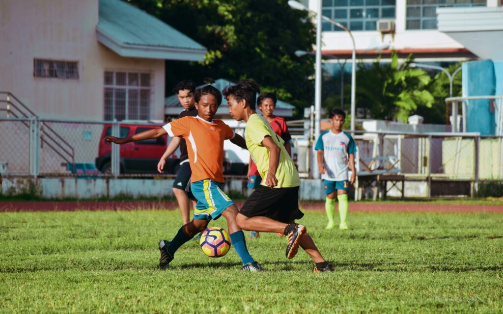 children playing soccer at a spring sports camp