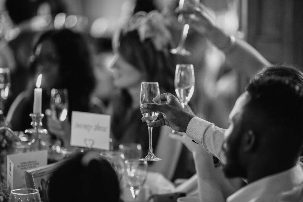 black and white photo of champagne toast by people that need liquor liability insurance for event