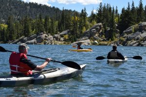 kayakers in the river after getting coverage for outdoor recreation liability insurance